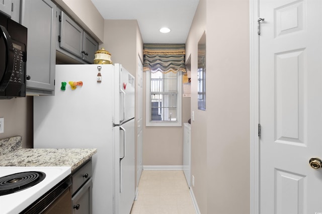 kitchen featuring gray cabinets and white appliances