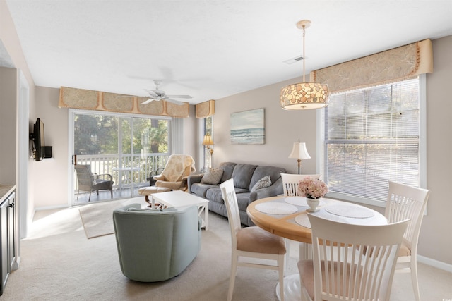 living room with light carpet and ceiling fan