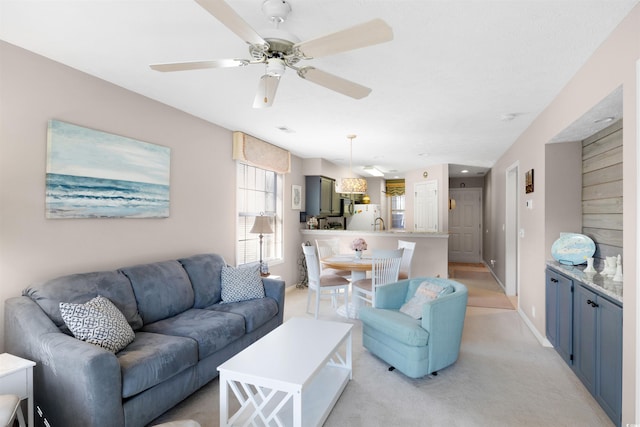 living room with ceiling fan and light carpet