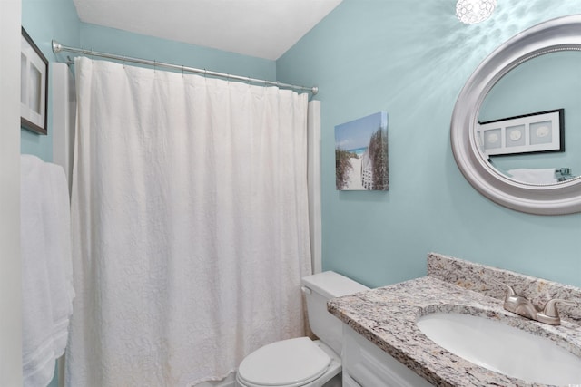 bathroom featuring vanity, a shower with shower curtain, and toilet