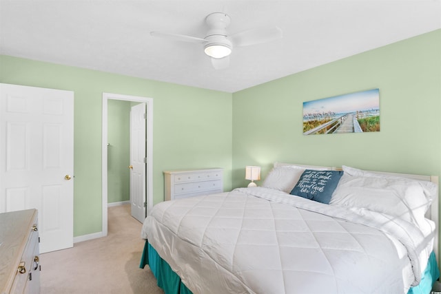 bedroom with ceiling fan and light carpet