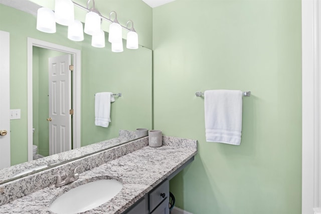 bathroom with vanity and toilet