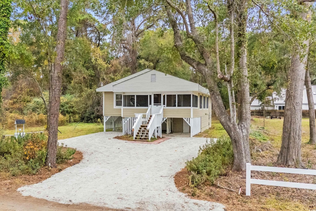 view of front of property featuring a sunroom