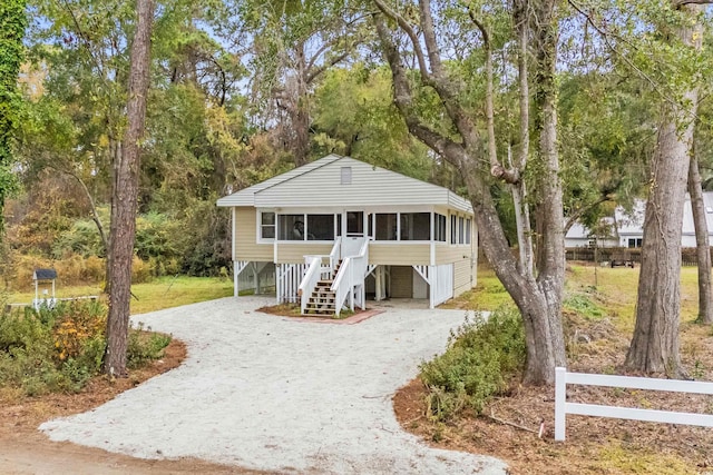 view of front of property featuring a sunroom