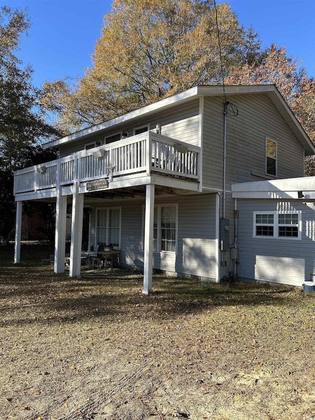 back of house featuring a wooden deck