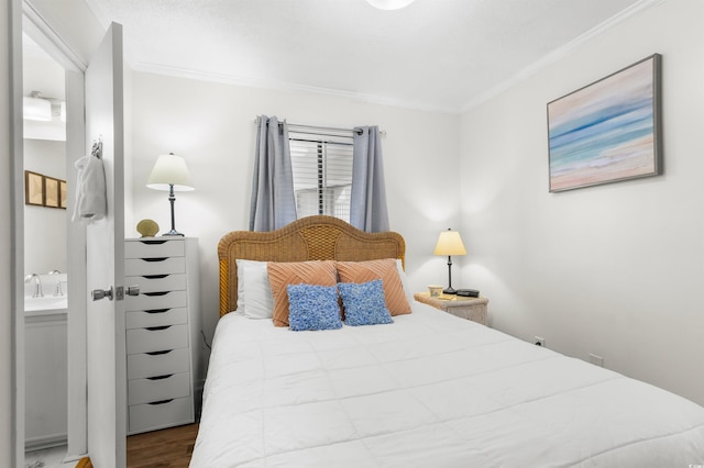 bedroom with dark hardwood / wood-style floors and ornamental molding