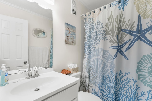 bathroom with vanity, toilet, crown molding, and walk in shower