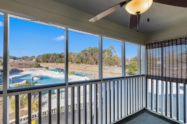 unfurnished sunroom with ceiling fan