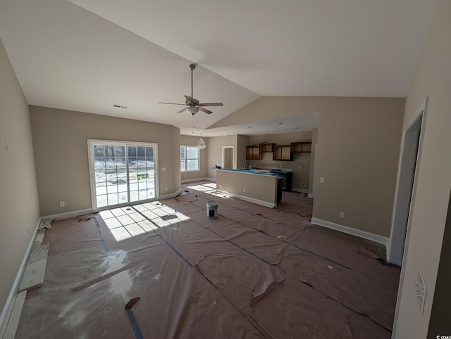 unfurnished living room with ceiling fan and lofted ceiling