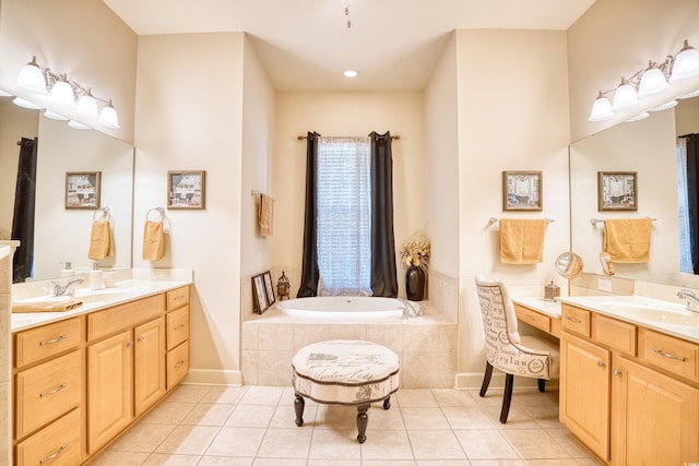 bathroom with tiled tub, tile patterned flooring, and vanity