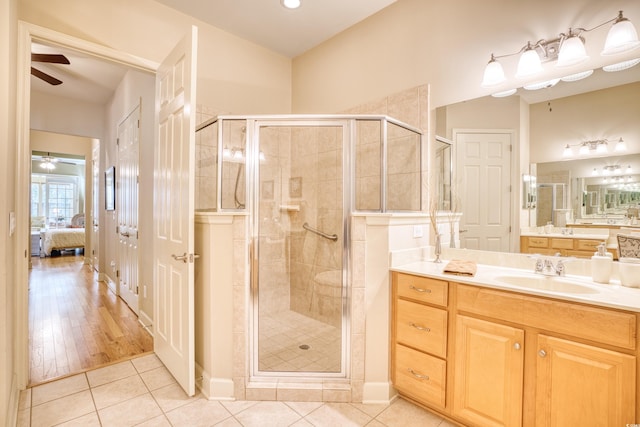 bathroom featuring hardwood / wood-style floors, vanity, and a shower with shower door