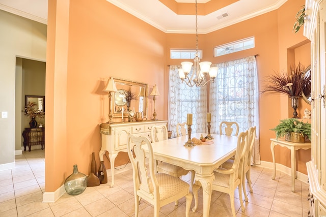 dining area featuring a notable chandelier, ornamental molding, a high ceiling, and light tile patterned floors