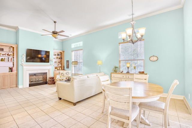 190 Sugar Loaf Ln, Murrells Inlet, SC 29576 - dining space with light tile patterned flooring, ornamental molding, a chandelier, a glass covered fireplace, and a ceiling fan