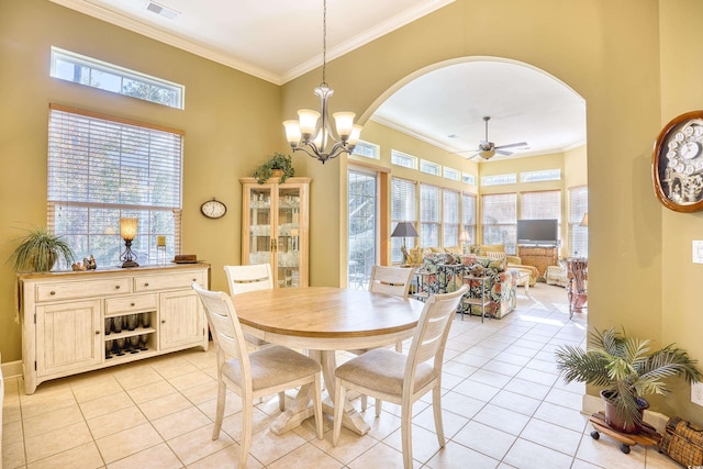 dining area with ceiling fan with notable chandelier, light tile patterned floors, and crown molding