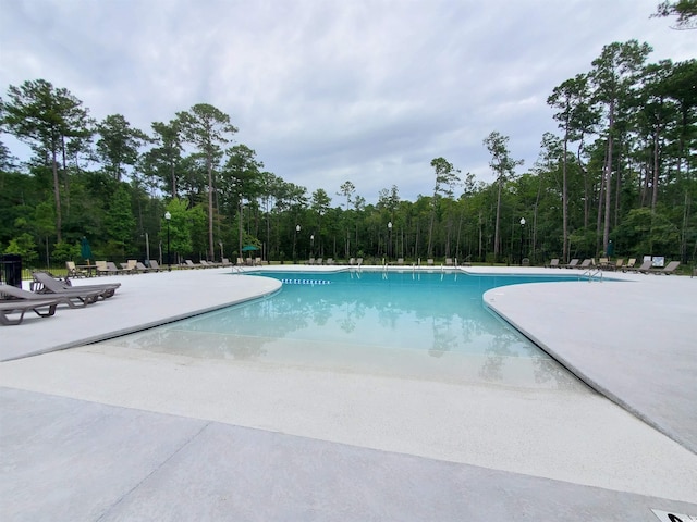190 Sugar Loaf Ln, Murrells Inlet, SC 29576 - community pool featuring a patio area and a wooded view