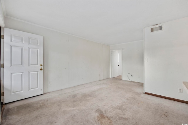 spare room featuring light carpet and ornamental molding