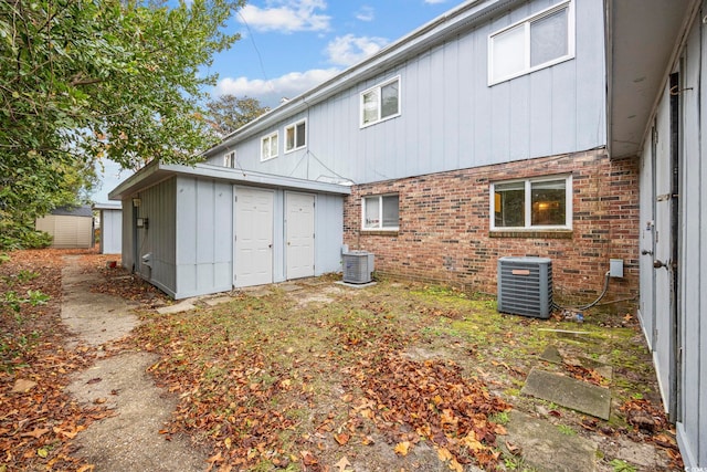 back of property with cooling unit and a storage shed