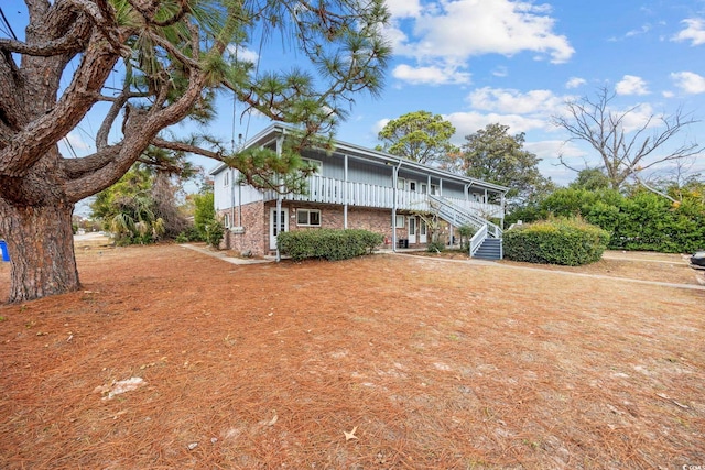 back of house featuring a porch