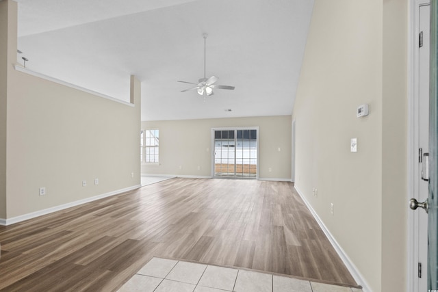 unfurnished living room featuring light hardwood / wood-style flooring, ceiling fan, and lofted ceiling