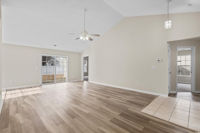 unfurnished living room featuring ceiling fan, high vaulted ceiling, and hardwood / wood-style flooring