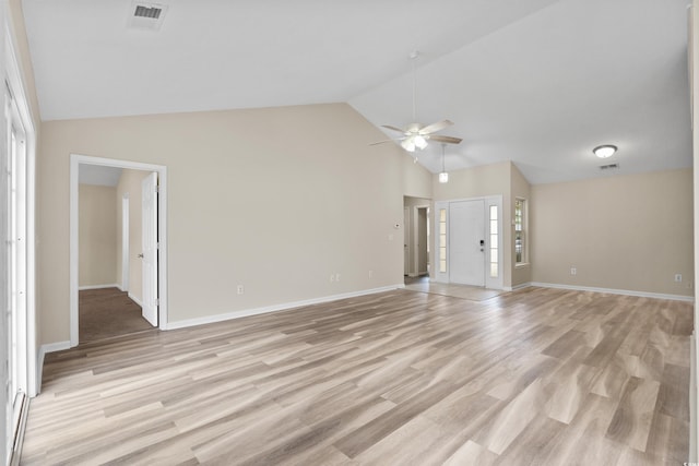 unfurnished living room featuring ceiling fan, light hardwood / wood-style floors, a healthy amount of sunlight, and vaulted ceiling