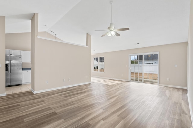 unfurnished living room featuring high vaulted ceiling, light hardwood / wood-style flooring, and ceiling fan