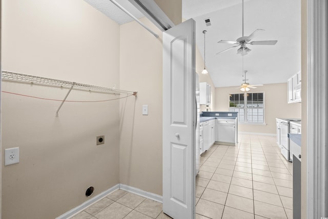 clothes washing area featuring ceiling fan, electric dryer hookup, and light tile patterned flooring