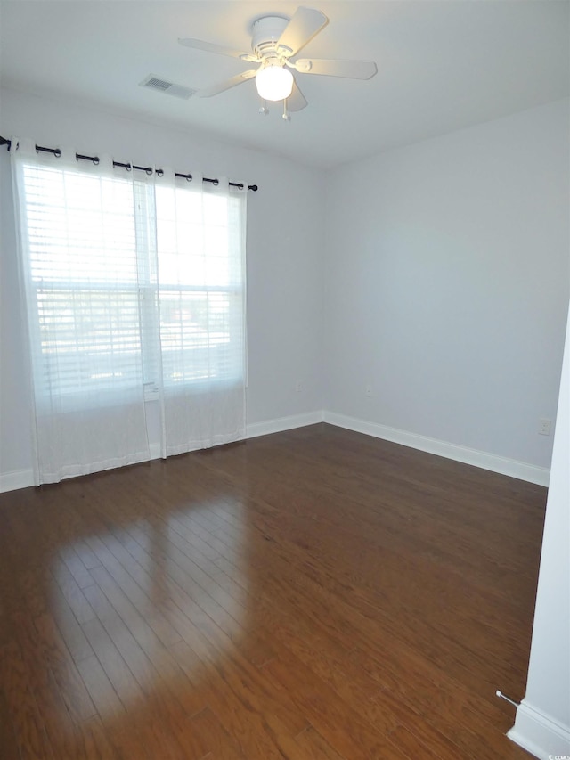 64 Summerlight Dr, Murrells Inlet, SC 29576 - spare room with visible vents, a ceiling fan, a wealth of natural light, and dark wood-type flooring