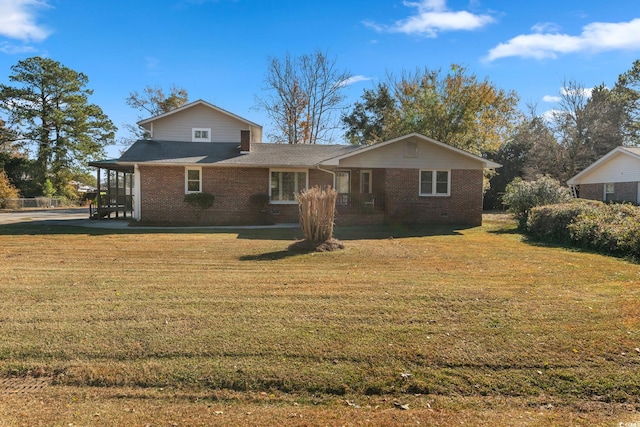 back of property featuring a yard