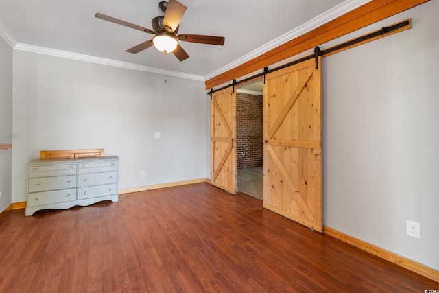 unfurnished bedroom with a barn door, crown molding, ceiling fan, and dark wood-type flooring