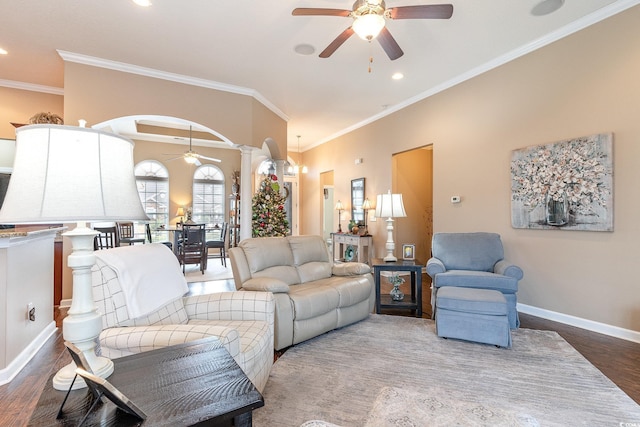 living room with decorative columns, hardwood / wood-style flooring, and crown molding