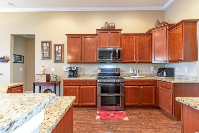 kitchen featuring light stone countertops, appliances with stainless steel finishes, backsplash, ornamental molding, and dark hardwood / wood-style floors