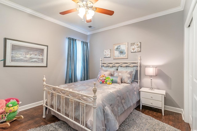 bedroom featuring dark hardwood / wood-style flooring, a closet, ceiling fan, and ornamental molding