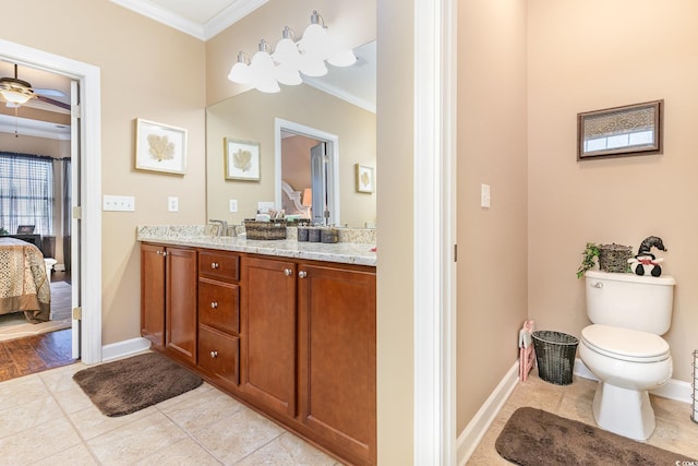 bathroom with toilet, vanity, tile patterned floors, and ornamental molding