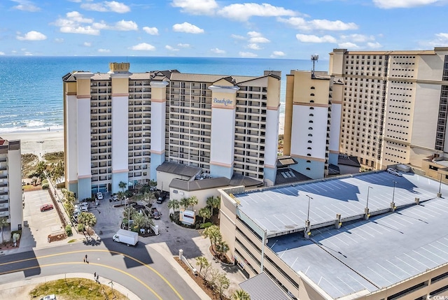 drone / aerial view with a water view and a beach view