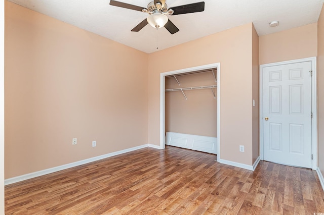 unfurnished bedroom with a closet, ceiling fan, and hardwood / wood-style floors