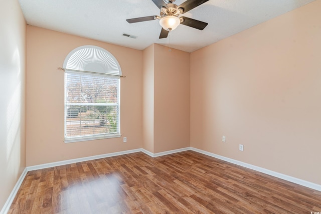 unfurnished room with hardwood / wood-style flooring, ceiling fan, and a textured ceiling