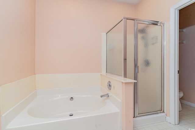 bathroom featuring tile patterned floors, toilet, and independent shower and bath