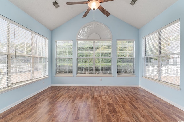 unfurnished sunroom featuring a wealth of natural light, ceiling fan, and vaulted ceiling