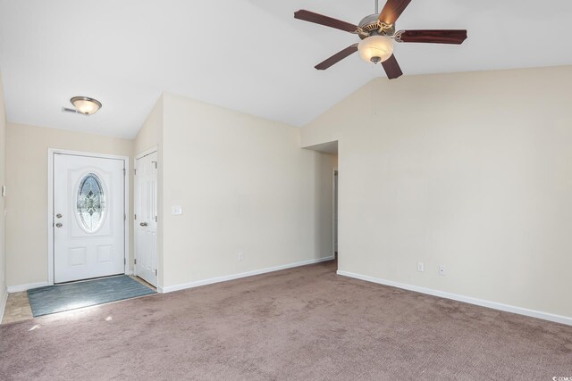 carpeted entryway featuring vaulted ceiling and ceiling fan