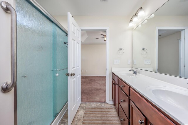 bathroom with vanity, ceiling fan, and an enclosed shower