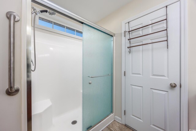 bathroom with a shower with shower door