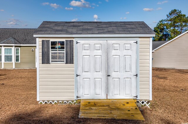 view of outbuilding featuring a lawn