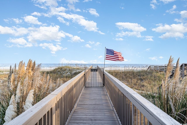 surrounding community featuring a beach view and a water view