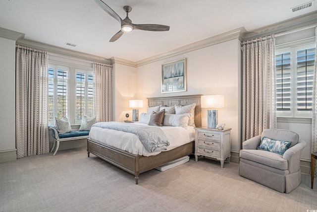 carpeted bedroom with ceiling fan and ornamental molding