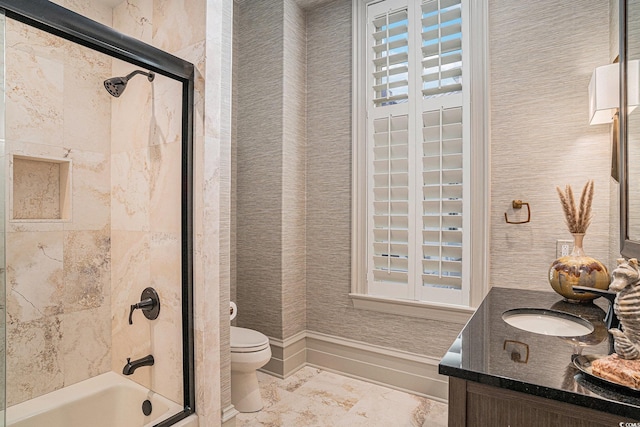 full bathroom with toilet, plenty of natural light, vanity, and combined bath / shower with glass door