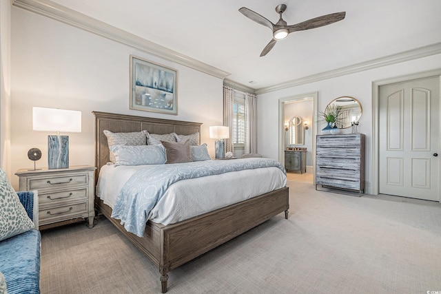 carpeted bedroom with ensuite bath, ceiling fan, and ornamental molding