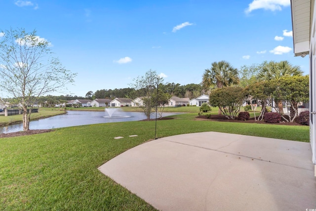 view of grassy yard with a water view and a residential view