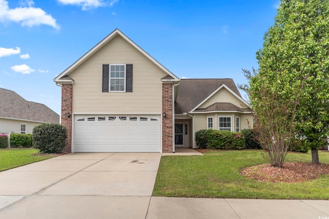 traditional-style home featuring concrete driveway, an attached garage, a front yard, and brick siding
