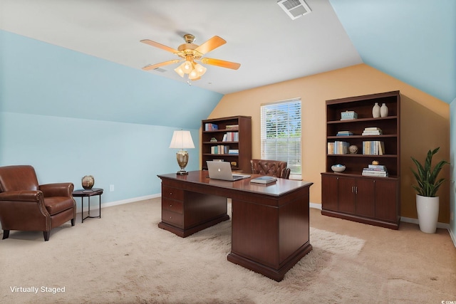 office space featuring lofted ceiling, light colored carpet, a ceiling fan, and baseboards